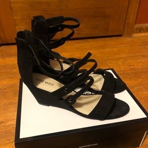 Black pair of Nine West Ilanao wedge sandals